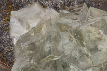Vibrant green fluorite crystals with cubic structure on a rocky matrix