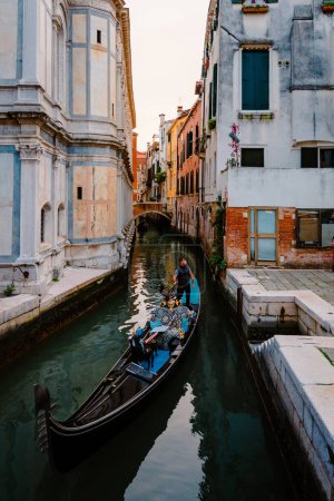 Photo for Venice, Italy - October 2022: Close-up of gondolier as he navigates the typical canals of Venice - Royalty Free Image