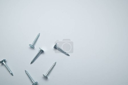 Téléchargez les photos : Set of metal nail head isolated on white background. Metallic nail for joining wooden detail. - en image libre de droit