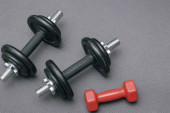 Dumbbells on a gray sports mat. Sports concept - gray mat, two black dumbbells. Active lifestyle sport. Workout at home or gym Poster #645849626