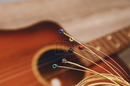 Téléchargez les photos : Nouvelles cordes de guitare acoustique, piocher sur la vieille guitare. - en image libre de droit