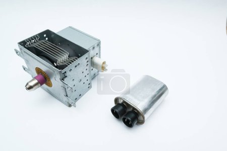 New magnetron and capacitor spare parts for microwave oven. Diagnostics repair of microwave oven.