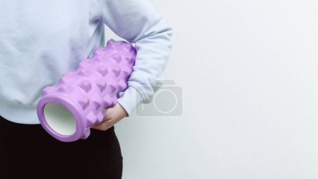 Woman holding massage rollers for myofascial release in her hands. Maintaining healthy lymphatic system concept, myofascial release. Equipment for myofascial release.