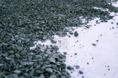 Geotextile layer between gravel. White Geotextile with gravel lies on a construction site. Modern construction technologies and materials. Driveway for construction equipment, empty Road