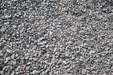 Crushed stone mounds. Crushed granite background. Rough texture, construction material background.