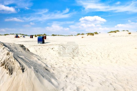 Island Borkum. North Sea beach with beach chairs and a blue sky