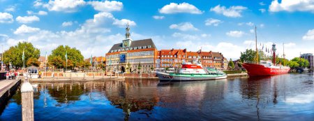 Photo for Panorama of the harbor of Emden city with townhall, historic light vessel and sailship, Lower Saxony, Germany - Royalty Free Image