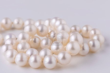 Photo for A very beautiful delicate pearl necklace close-up on a light background , a gift to a beloved woman - Royalty Free Image