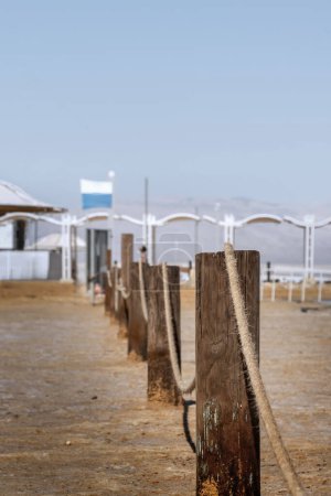 wooden fence posts along the Dead Sea coast , selective focus