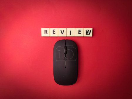 Photo for Toys word and wireless mouse with the word REVIEW on red background.Business concept. - Royalty Free Image