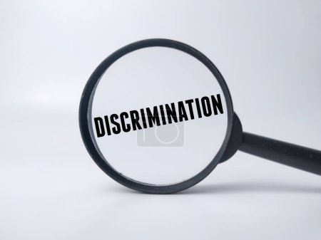 Magnifying glass with the word DISCRIMINATION on a white background.Business concept.