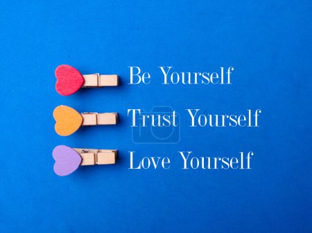 Photo for Wooden clips with the word Be yourself Trust yourself Love yourself on a blue background - Royalty Free Image