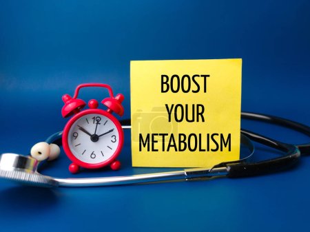 Alarm clock and stethoscope with the word BOOST YOUR METABOLISM on a blue background