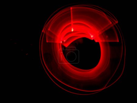 Photo for Red light painting, long exposure photography, ripples and round pattern with black background. - Royalty Free Image