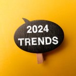 Wooden sign board with the word 2024 TRENDS on yellow background