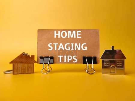 Photo for House keychain and card board with the word HOME STAGING TIPS on yellow background - Royalty Free Image