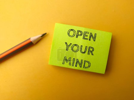 Photo for Sticky note and pencil with the word OPEN YOUR MIND on yellow background - Royalty Free Image