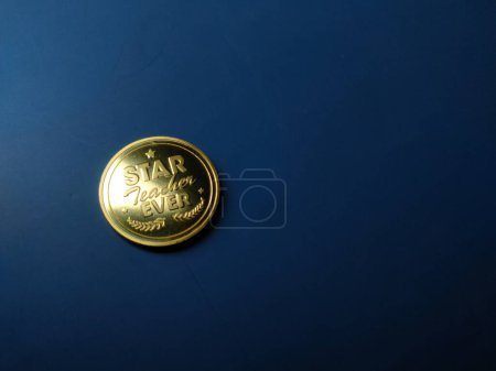 Photo for Gold coin gift for Happy teacher day on a blue background with copy space. - Royalty Free Image