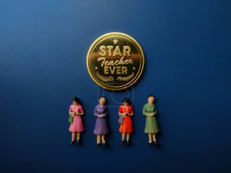 Photo for Gold coin gift for Happy teacher day with miniature people on blue background - Royalty Free Image