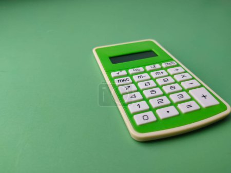 Photo for Closeup green calculator on a green background. Business concept. - Royalty Free Image