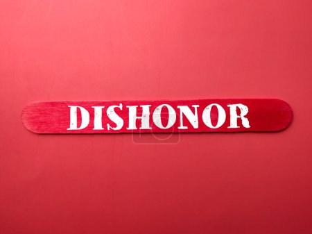 Photo for Colored ice cream stick with the word DISHONOR on a red background - Royalty Free Image