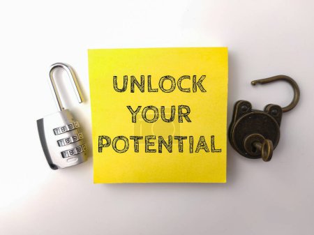 Photo for Padlock and sticky note with the word UNLOCK YOUR POTENTIAL on a white background - Royalty Free Image