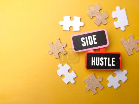 Photo for Top view white puzzle with text SIDE HUSTLE on a yellow background. - Royalty Free Image