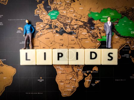 Photo for Top view miniature people and toys word with text LIPIDS on a world map background - Royalty Free Image