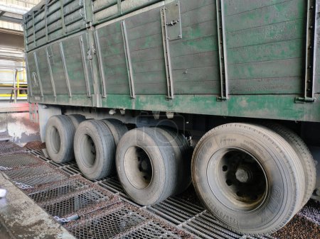 Photo for Malaysia, 11 March 2022: Eight tires on the side of a trailer truck carrying kernal seeds. - Royalty Free Image