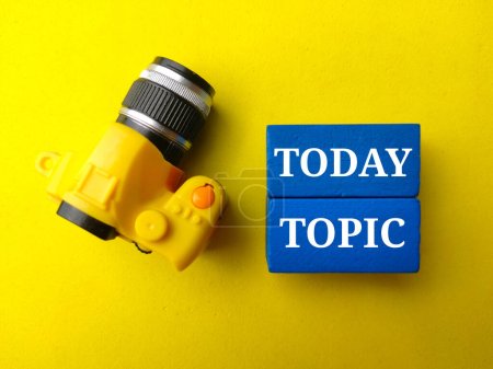 Photo for Top view toy camera with text TODAY TOPIC on yellow background. - Royalty Free Image