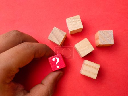 Photo for Top view wooden block with symbol question mark on red background. - Royalty Free Image