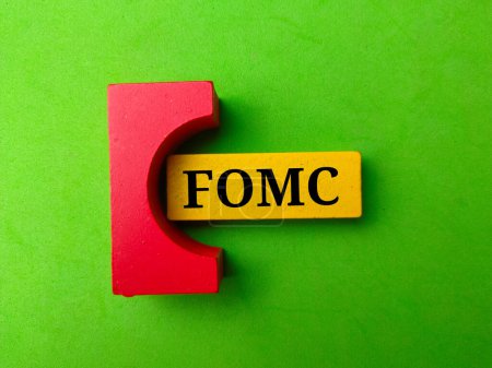 Top view colored block with text FOMC on green background.