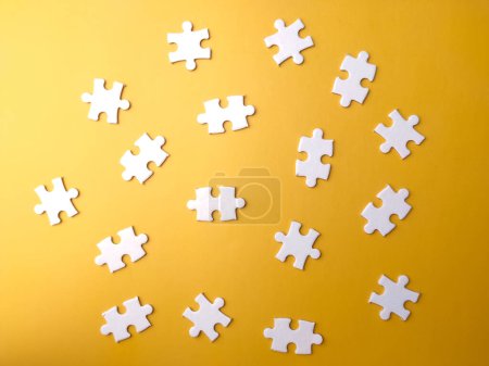 Photo for Top view blank white puzzle on a yellow background. - Royalty Free Image