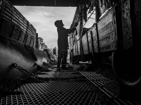 Photo for Malaysia, Perak, 9 Febuary 2022: A foreign contract worker is cleaning a lorry. - Royalty Free Image