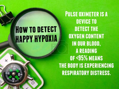 Top view magnifying glass,compass and calculator with tips How to detect HAPPY HYPOXIA on green background. Healthcare concept.
