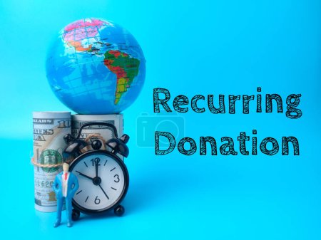 Earth globe,banknotes,miniature people and clock with text Recurring Donation on blue background.