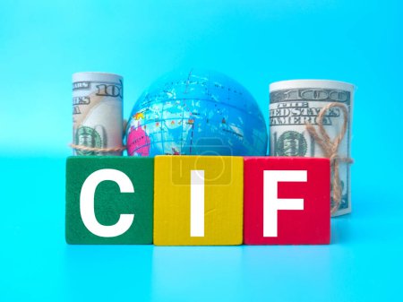Colored wooden cube,banknotes and earth globe with text CIF on blue background