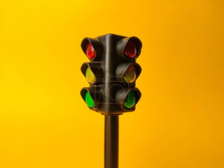 Mini traffic lights on a yellow background. Can use for background and so on.