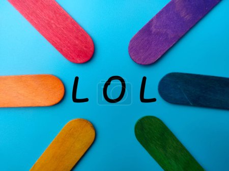 Colored ice cream stick with the word LOL Laugh Out Loud on a blue background.