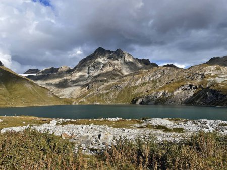 Valley Vistas: High-Altitude Trail Adventure by Lake in Val d'Isere, aiguille de la grande sasseire, France