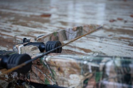 Photo for A frayed, worn out, broken bowstring that will need to be replaced.  This is general maintenance on compound and crossbows, and is very important to keep in good repair. Shallow depth of field. - Royalty Free Image