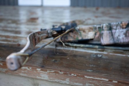 Photo for A frayed, worn out, broken bowstring that will need to be replaced.  This is general maintenance on compound and crossbows, and is very important to keep in good repair. Shallow depth of field. - Royalty Free Image