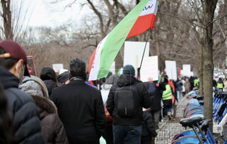 Photo for Iranians Protesting in New York. January 08, 2023, New York, USA: Some Iranians marched along 5th Avenue from 61st street upward chanting, displaying banners and protesting against the Iranian government due to the Imposition of Islamic law - Royalty Free Image