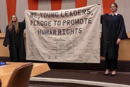 Photo for International Mock Trial on Human Rights. January 31, 2023, New York, New York, USA: Students hold pledge banner during a special event International Mock Trial on Human Rights - Royalty Free Image