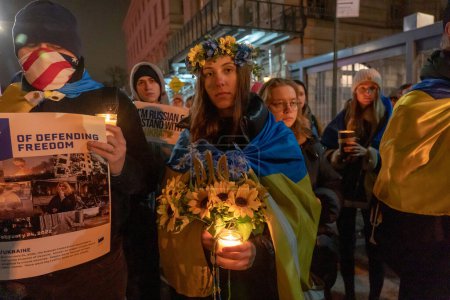 Photo for Candlelight Vigil For Ukraine's Resilience and Resistance. February 23, 2023, New York, USA: People with Ukrainian Flags, anti-war sign and candles gather at a candlelight vigil on the eve of the one year anniversary of full-scale Russian invasion - Royalty Free Image