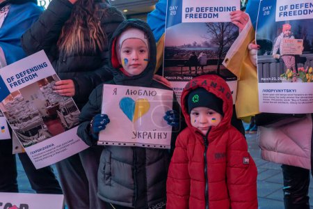 Téléchargez les photos : People Across North America Gather To Support Ukraine On The Anniversary Of The Russian Invasion. February 24, 2023, New York, New York, USA: Alexander, 7 years old, and Matthew, 3 years old, participate at a protest of the war in Ukraine - en image libre de droit