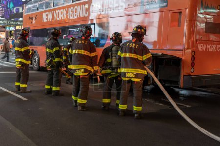 Foto de Tour Bus Brakes Fire. February 24, 2023, New York, New York, USA: F.D.N.Y. Firefighters on the scene of a tour bus brake fire from overheating at Times Square on February 24, 2023 in New York City - Imagen libre de derechos