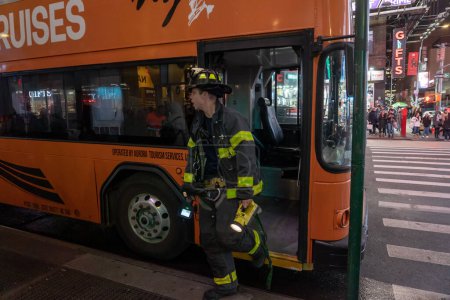 Photo for Tour Bus Brakes Fire. February 24, 2023, New York, New York, USA: F.D.N.Y. Firefighters on the scene of a tour bus brake fire from overheating at Times Square on February 24, 2023 in New York City - Royalty Free Image