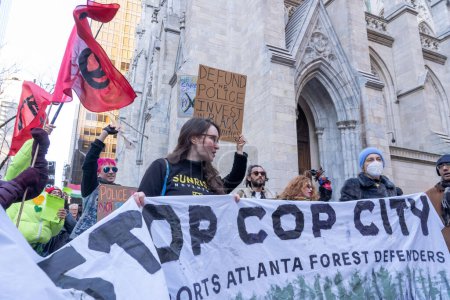 Photo for Activists In NYC Demonstrate Against Atlanta's Planned "Cop City" Police Training Center. March 09, 2023. New York, USA: Activists holding sign and banners protest against the proposed Cop City being built in an Atlanta forest on March 09, 2023 - Royalty Free Image