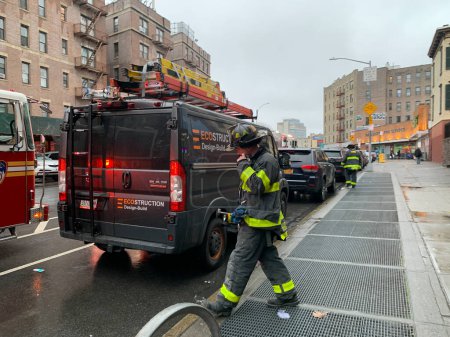 Photo for Firemen at Work. March 13, 2023, New York, USA: Firemen were called for to stop fire at a Public library on Saint Nicholas Avenue in Washington heights in New York, but on arrival, the firemen discovered it was a false alarm. - Royalty Free Image